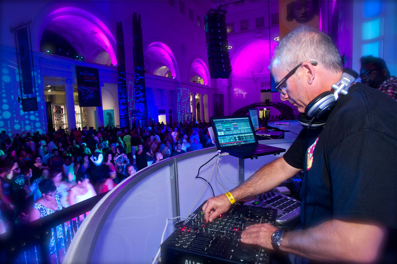 Scott Smokin' Silz performing behind the DJ booth at a large Chicago venue