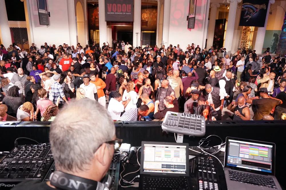 Scott DJing for a packed crowd at the Field Museum with hundreds dancing