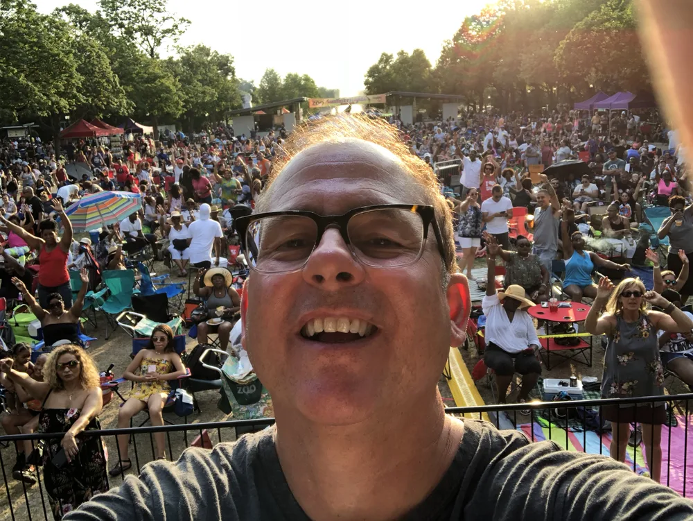 Scott Silz with a packed dance floor behind him at a nightlife event