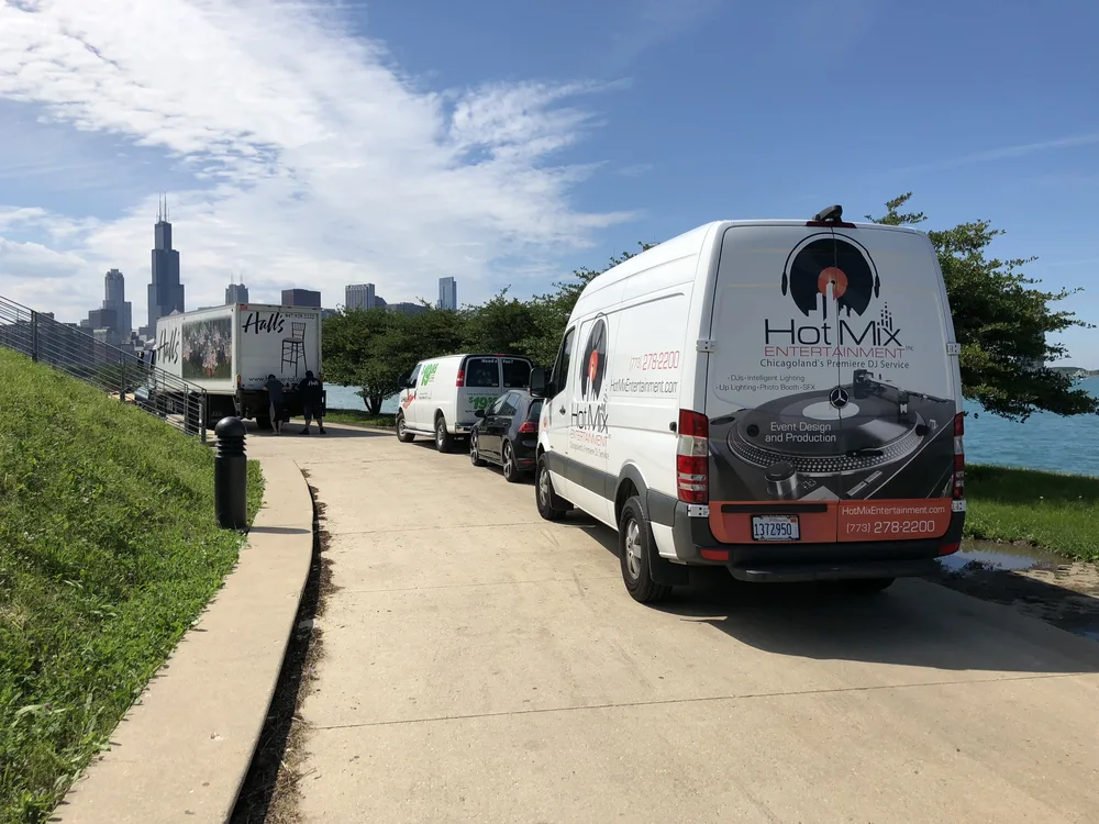 Hot Mix Entertainment van parked on Chicago lakefront with city skyline