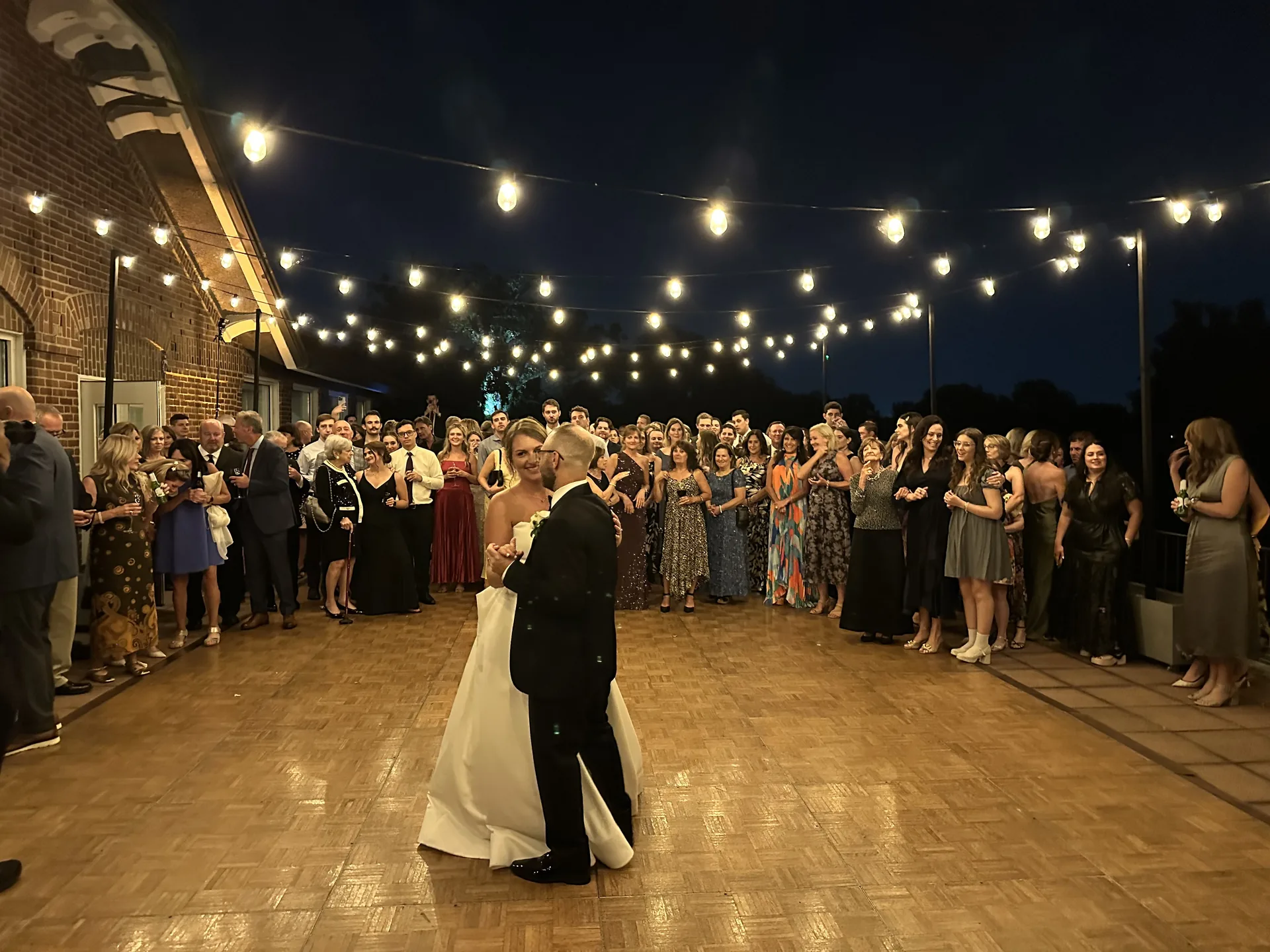 Guests dancing outdoors at a summer wedding party