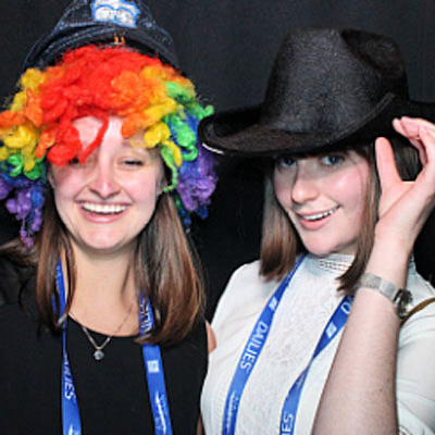 Friends laughing together inside an event photo booth