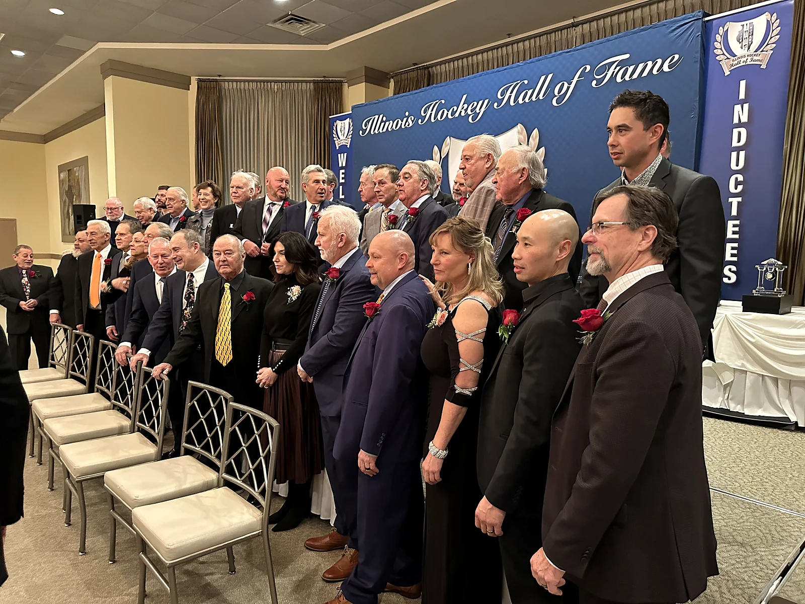 Inductees posing for a group photo at a formal hall of fame awards ceremony
