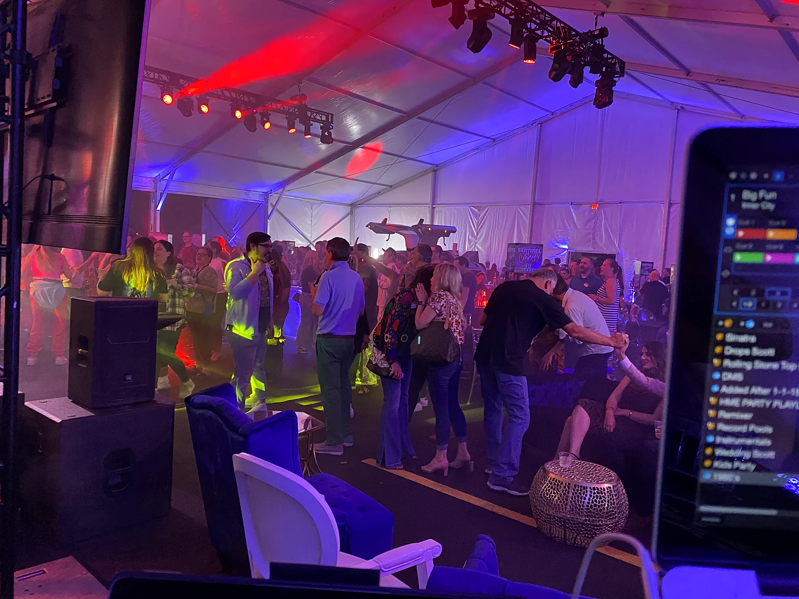 Crowd filling a vintage hall dance floor under red and purple lighting