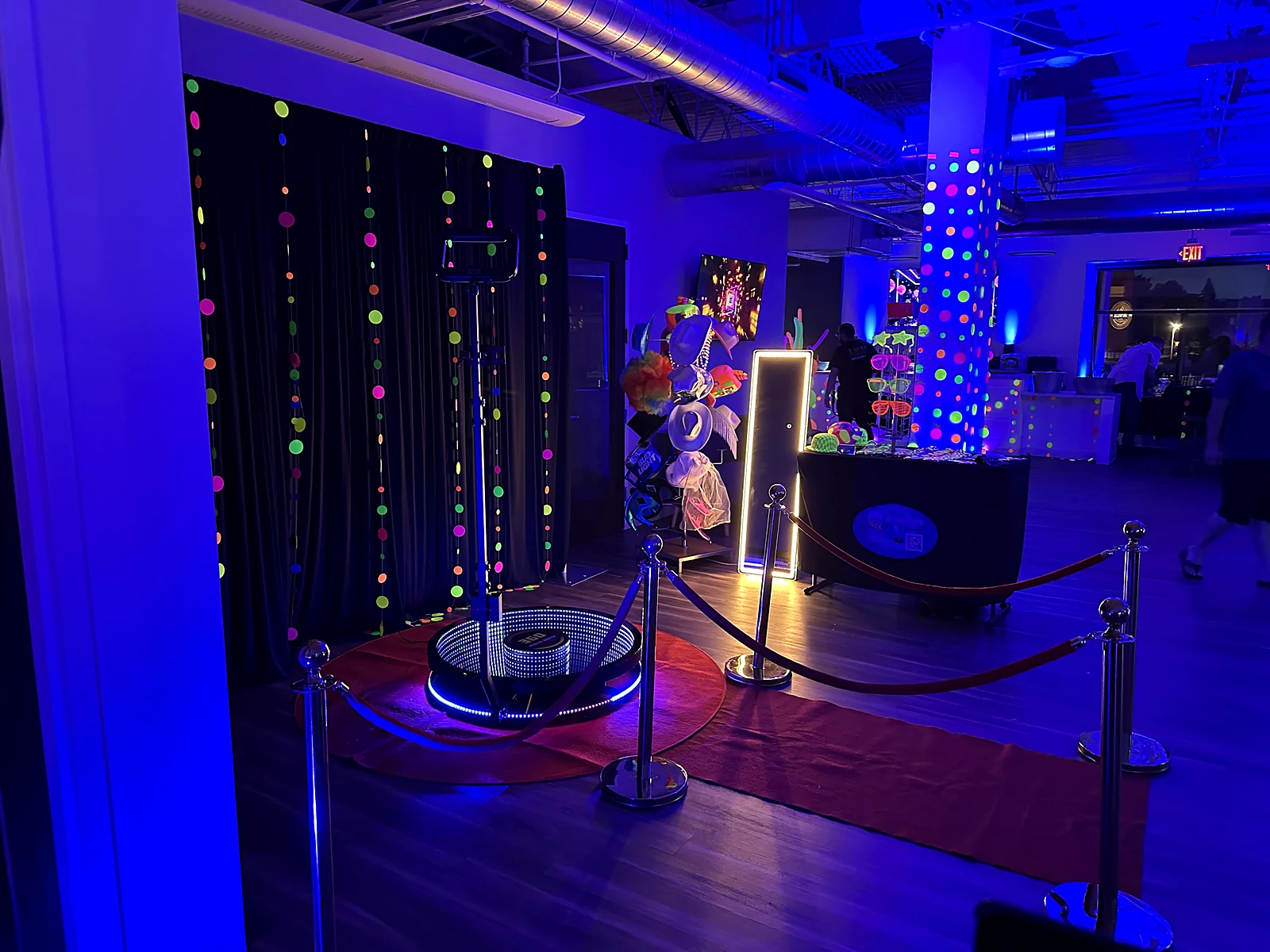 Sweet 16 beverage bar with neon display and blue uplighting