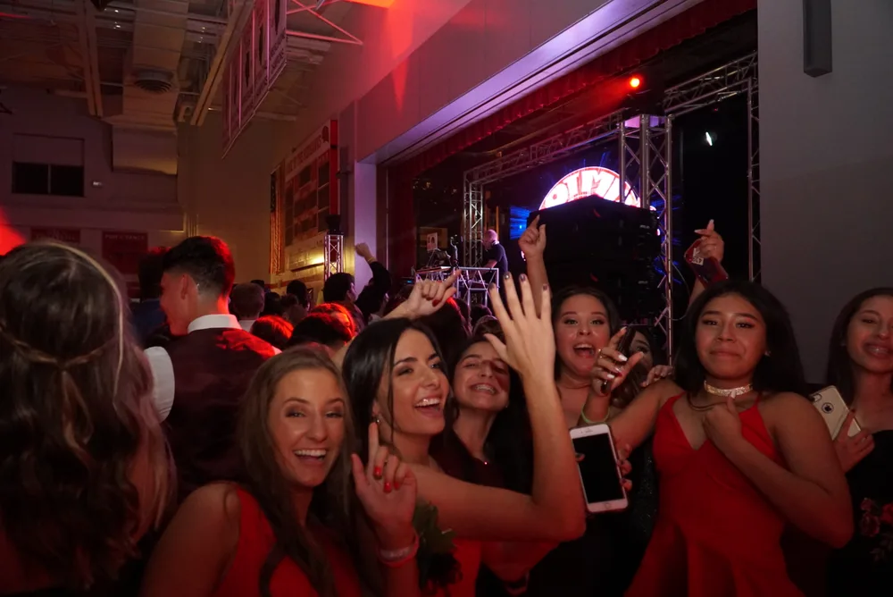 Students dancing and posing in front of the Hot Mix DJ stage