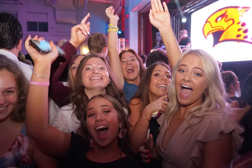 Friends laughing and celebrating together on the dance floor