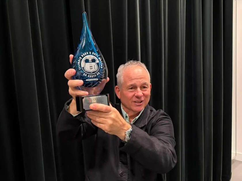 Scott Smokin’ Silz holding up his Illinois Rock & Roll Hall of Fame trophy at his induction on September 27, 2026