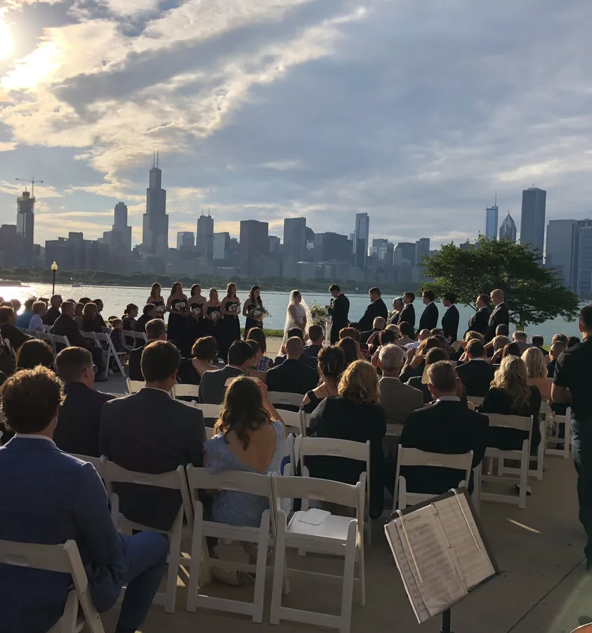 Outdoor wedding ceremony with the Chicago skyline and Lake Michigan behind the couple